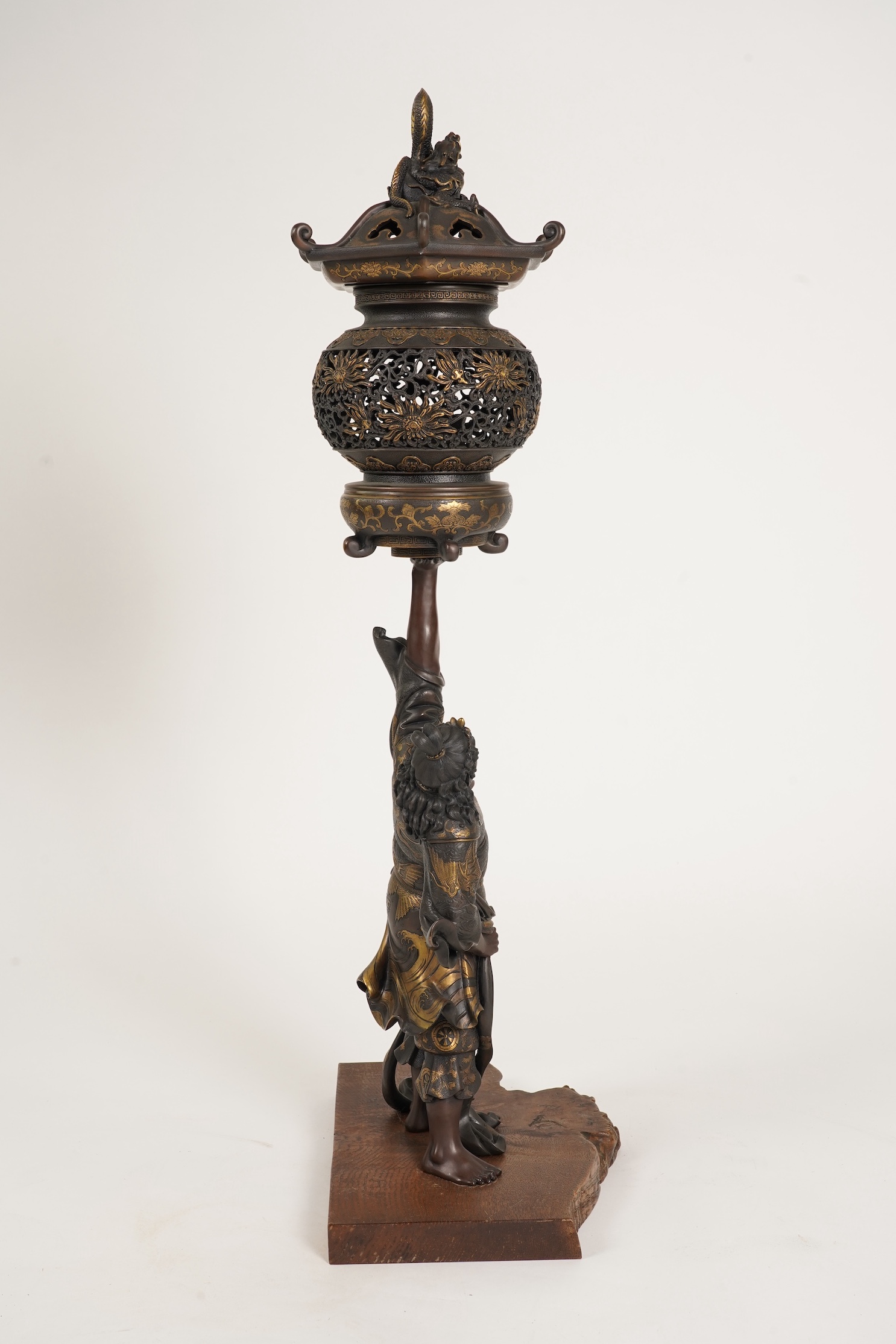 A large Japanese Miyao style parcel gilt bronze figure holding a koro aloft, 20th century